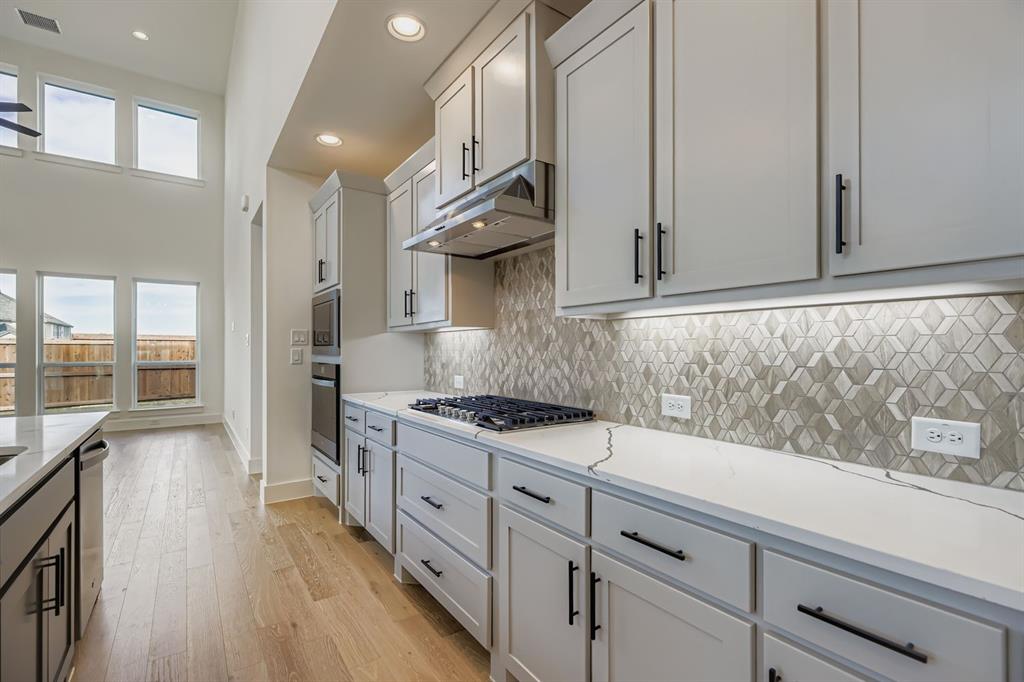 2608 Cedar Rdg Road Celina, TX 75009 - Photo 10 of 29 a kitchen with granite countertop a sink a stove and cabinets