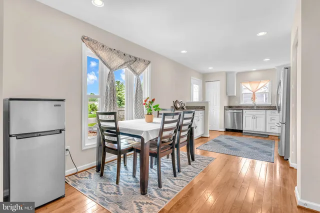 a view of a dining room with furniture window and wooden floor