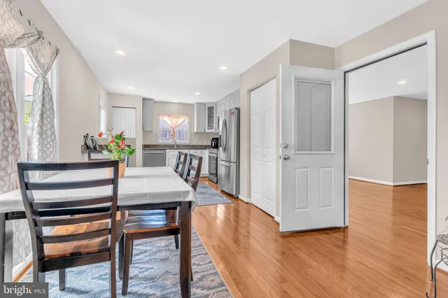 a view of a hallway with furniture and wooden floor