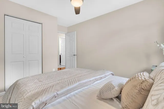 a bedroom with a bed and a large mirror