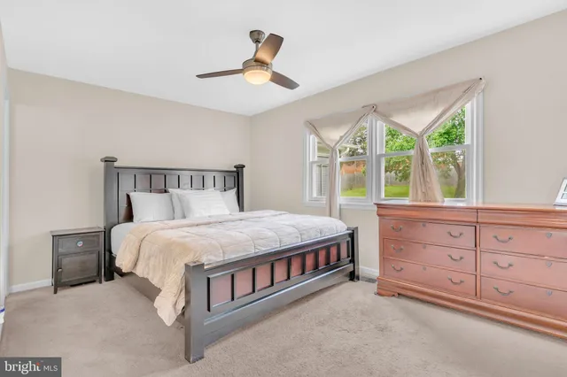 a bedroom with a large bed and a window