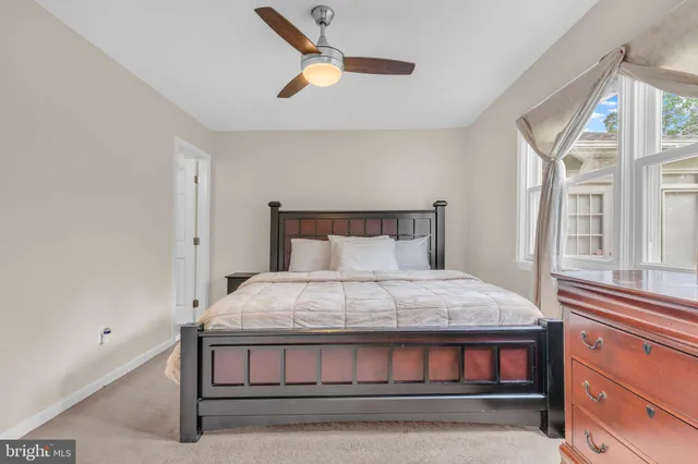 a bed sitting in a bedroom next to a window
