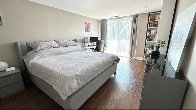 a bedroom with a bed and a desk
