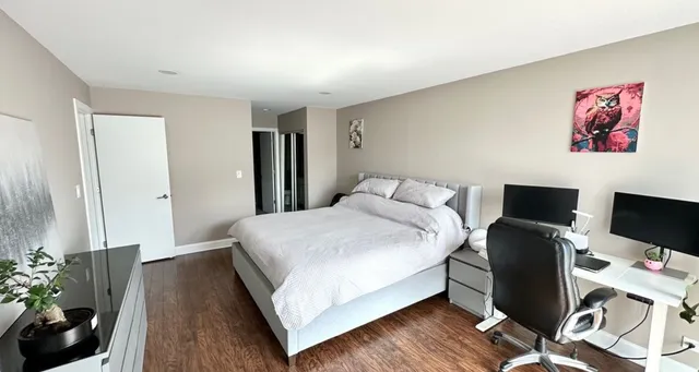 a view of a hallway view with wooden floor and staircase