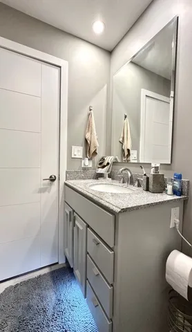 a balcony with wooden floor table and chairs