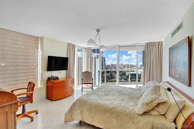 a bedroom with furniture and a flat screen tv