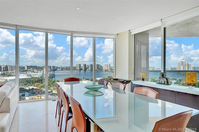a dining room with furniture a window and a kitchen view