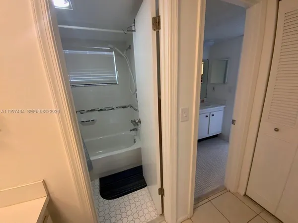 a bathroom with a tub and a sink