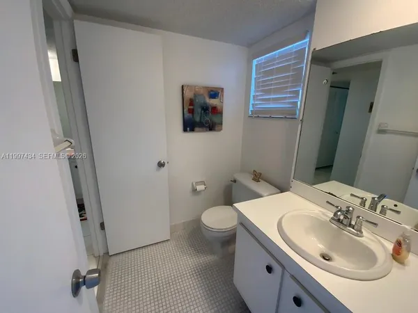 a bathroom with a sink toilet and vanity
