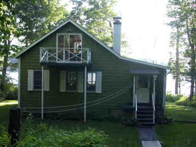 907 Algerie Road Otis, MA 01029 - Photo 4 of 8 a front view of a house with garden