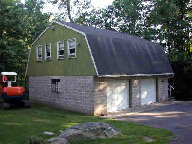 907 Algerie Road Otis, MA 01029 - Photo 5 of 8 a front view of a house with a garden
