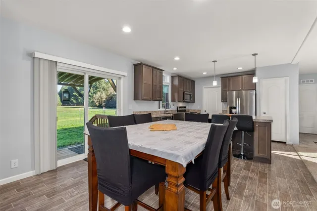 a view of a dining room with furniture window and wooden floor