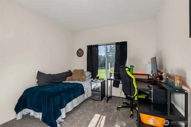 a bedroom with furniture and a flat screen tv