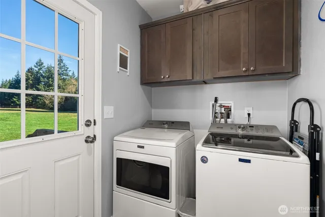 a kitchen with granite countertop a stove and a white cabinets