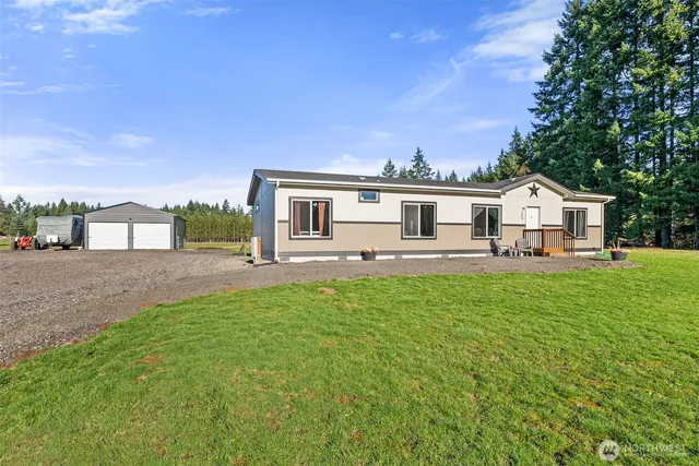 a view of a house with a backyard and a patio