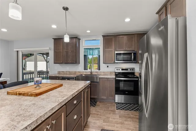 a kitchen with a sink stove and refrigerator