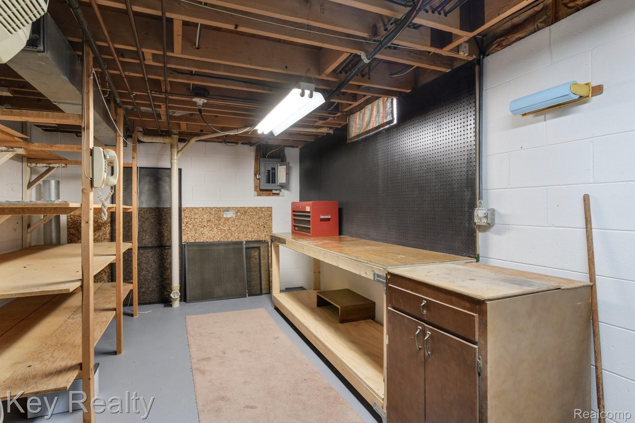 6231 Kings Shire Road Grand Blanc, MI 48439 - Photo 35 of 39 Wonderful basement storage and work area!