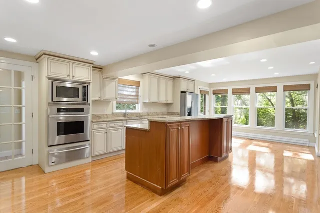 a kitchen with stainless steel appliances granite countertop a stove a sink and a refrigerator