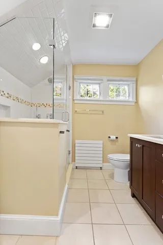 a bathroom with a toilet a sink and mirror