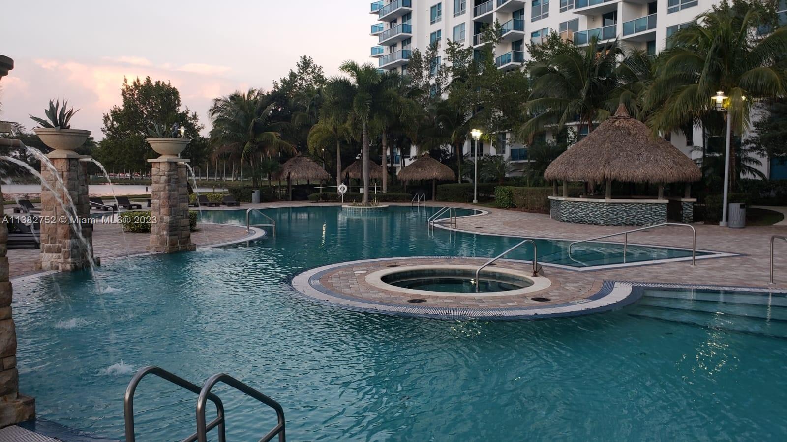 2681 North Flamingo Road, Unit 604S Sunrise, FL 33323 - Photo 1 of 18 a backyard of a house with fire pit and outdoor seating