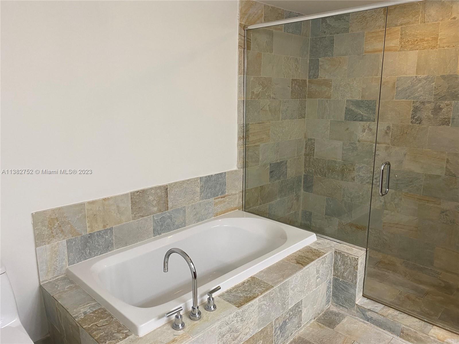 2681 North Flamingo Road, Unit 604S Sunrise, FL 33323 - Photo 13 of 18 a bathroom with a bathtub and shower
