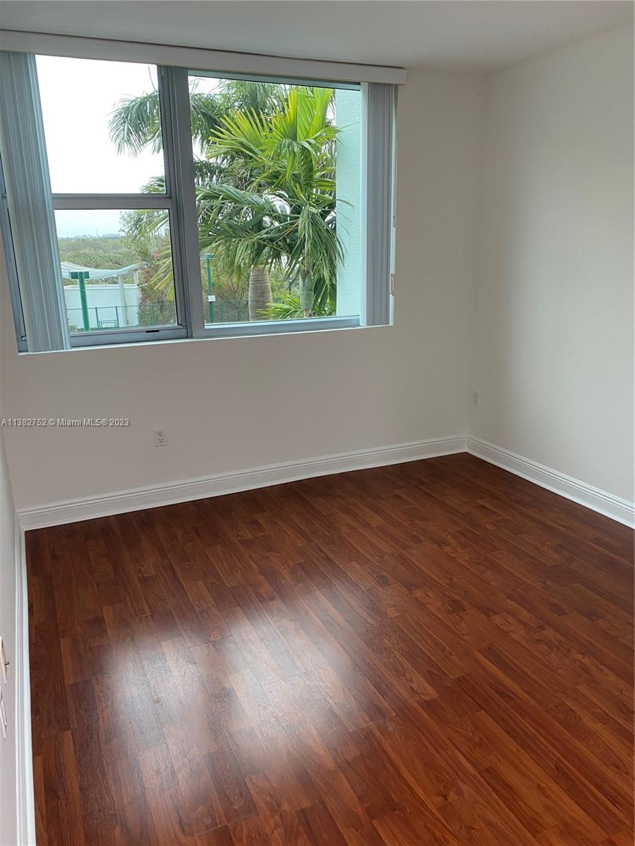 2681 North Flamingo Road, Unit 604S Sunrise, FL 33323 - Photo 15 of 18 an empty room with wooden floor and windows