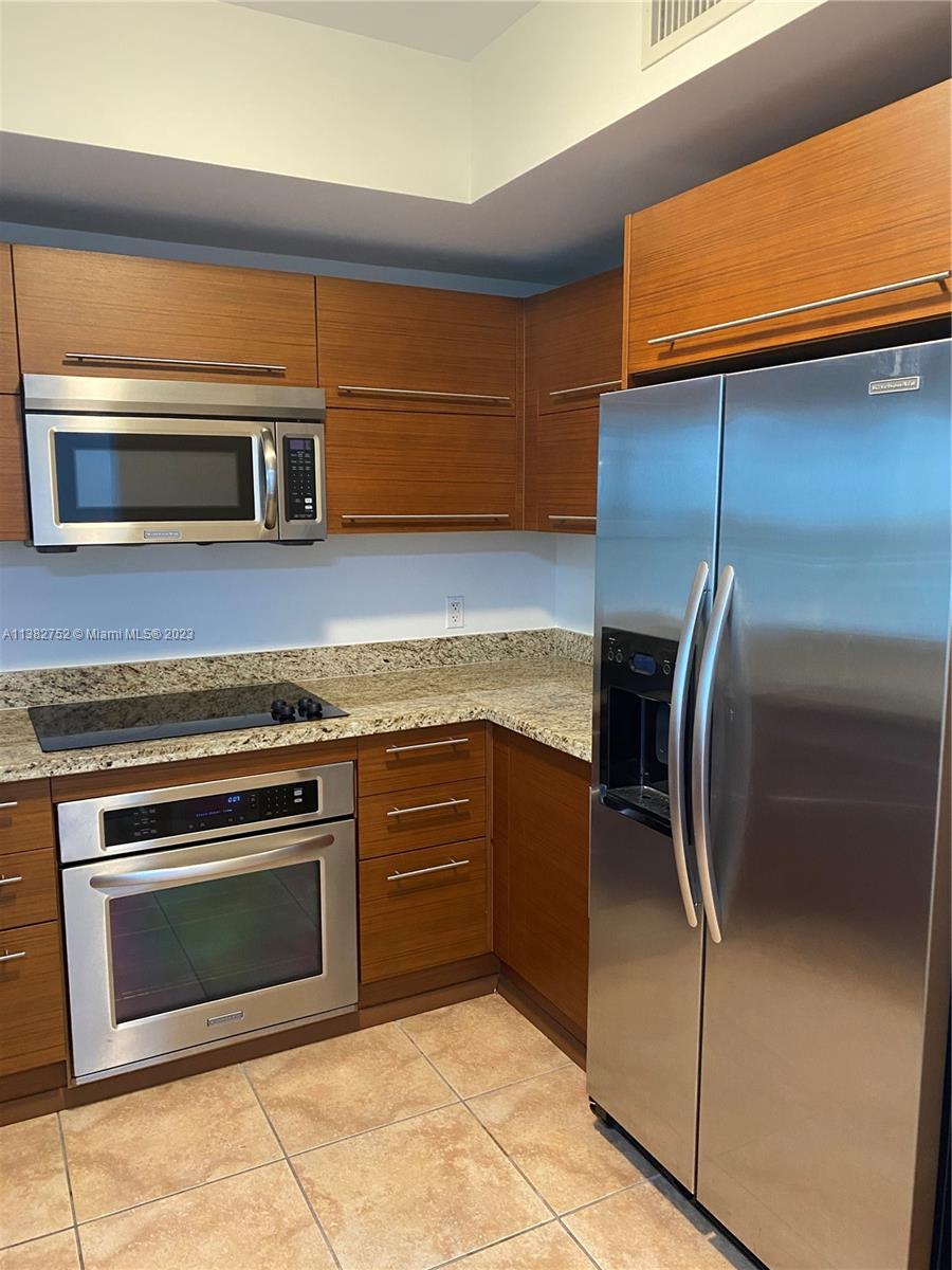 2681 North Flamingo Road, Unit 604S Sunrise, FL 33323 - Photo 16 of 18 a kitchen with a stove microwave and fridge