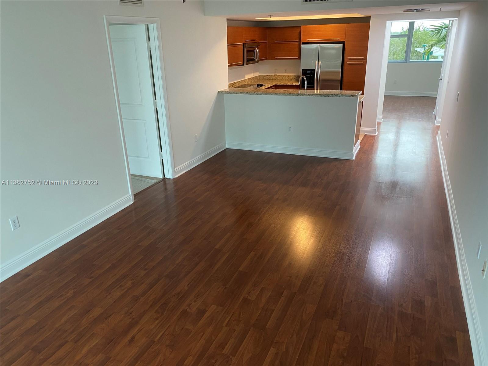 2681 North Flamingo Road, Unit 604S Sunrise, FL 33323 - Photo 18 of 18 a view of a kitchen with wooden floor and electronic appliances