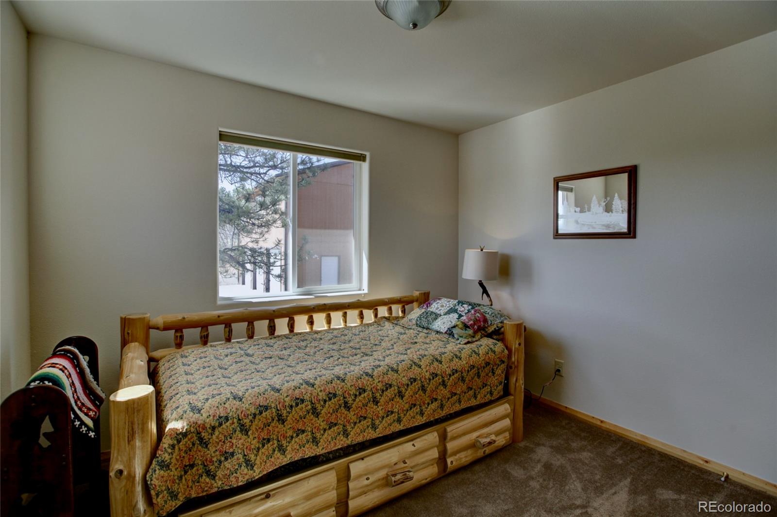 530 Red Feather Road Cotopaxi, CO 81223 - Photo 28 of 46 a bedroom with a bed and window