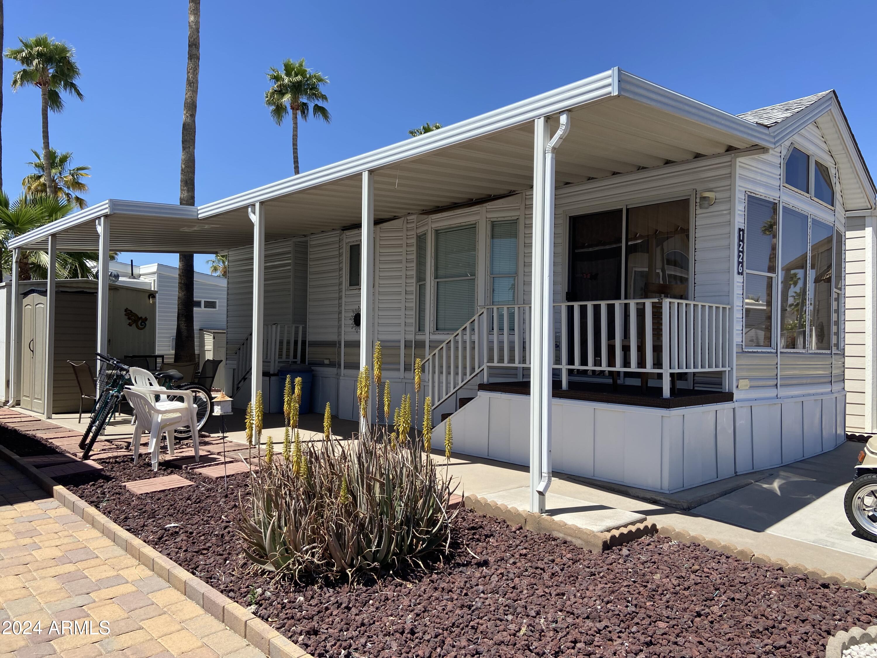 1226 Seneca Drive Apache Junction, AZ 85119 - Photo 1 of 23 a view of a house with wooden floor and a potted plant