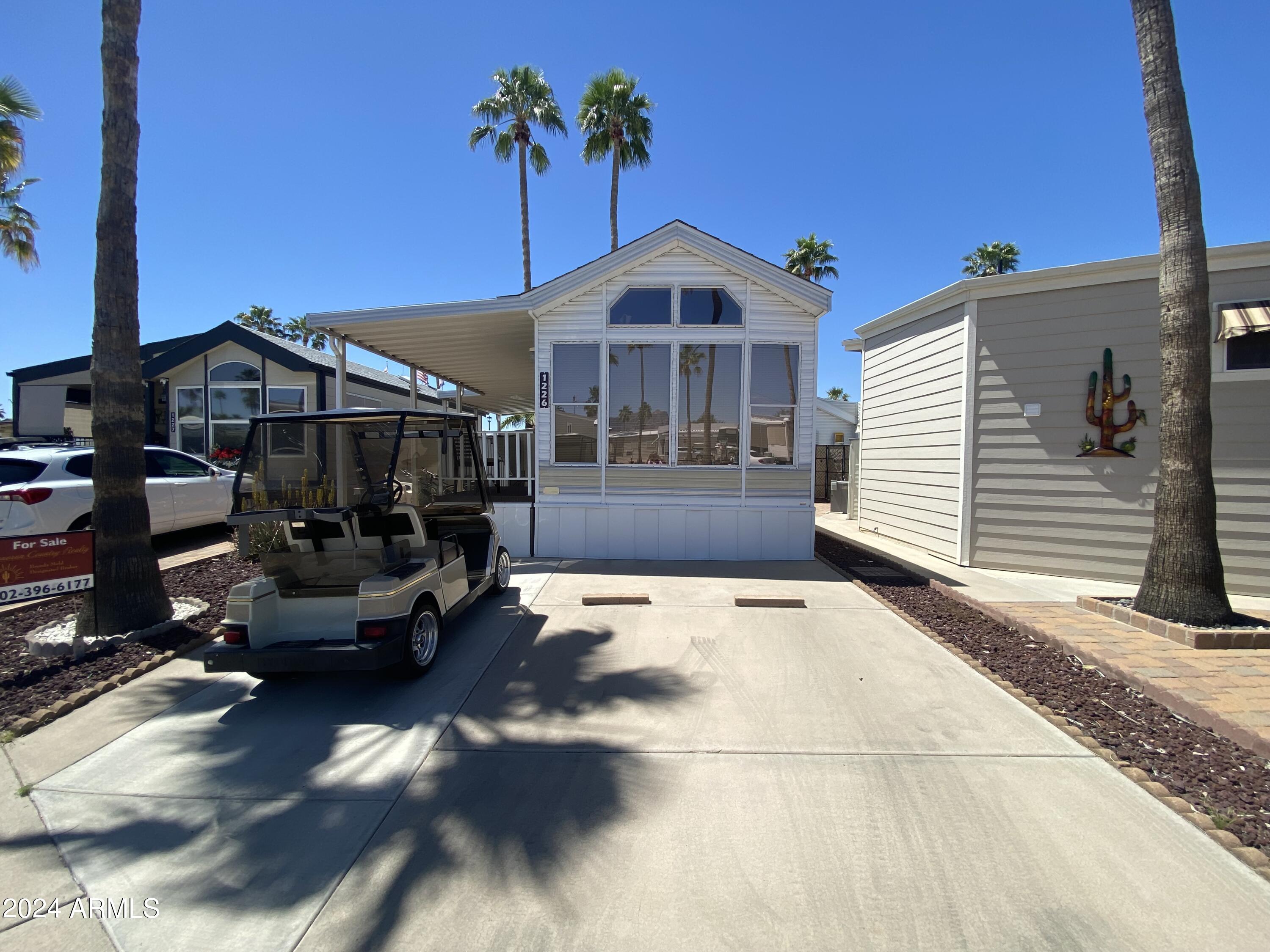 1226 Seneca Drive Apache Junction, AZ 85119 - Photo 16 of 23 a view of a white house with a patio