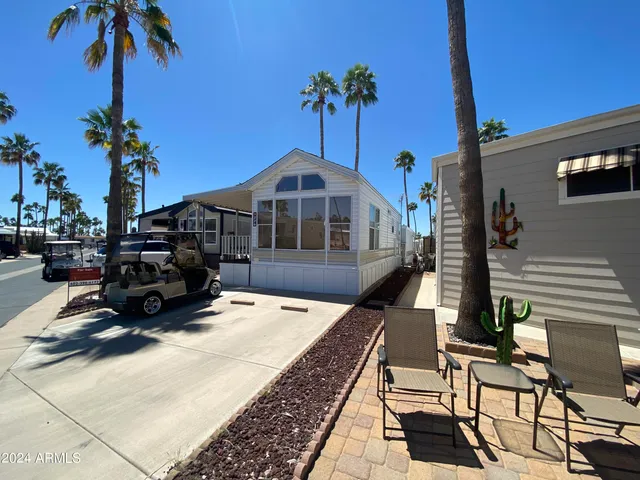 a front view of a house with sitting area and potted plants