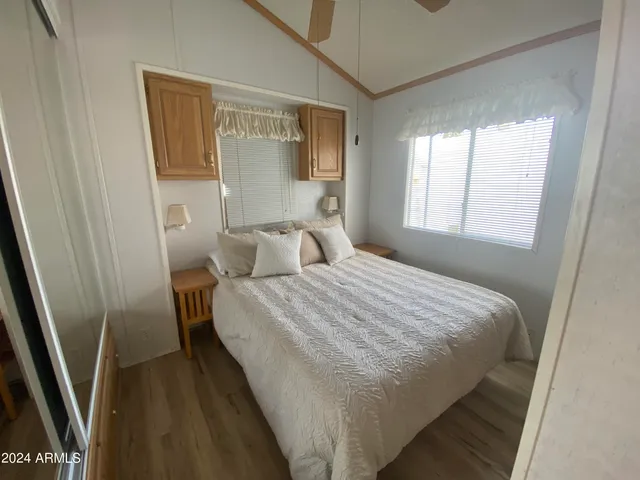 a bedroom with a bed and a mirror