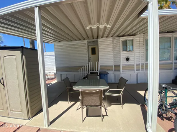 a patio with a table and chairs