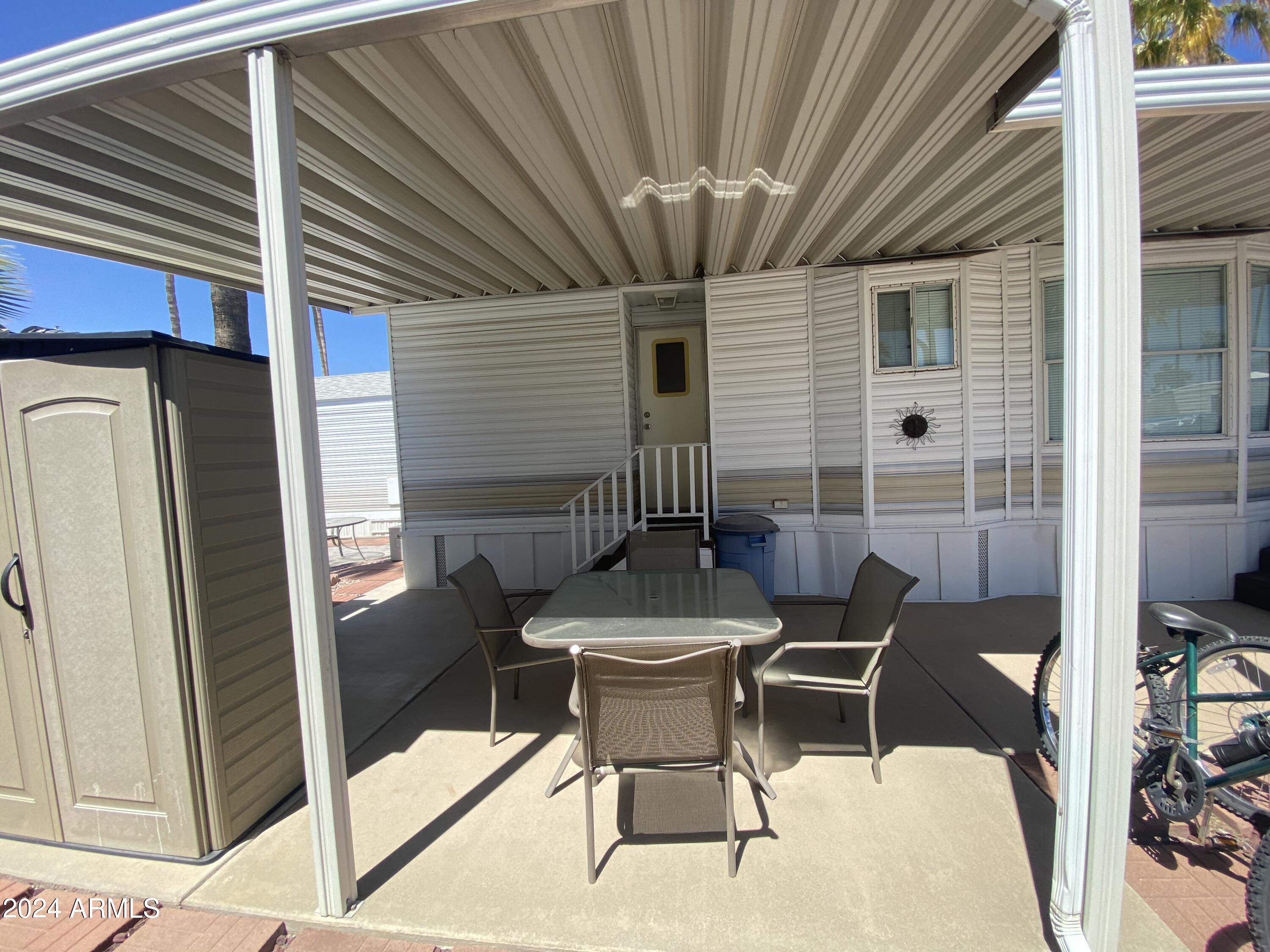 1226 Seneca Drive Apache Junction, AZ 85119 - Photo 21 of 23 a patio with a table and chairs