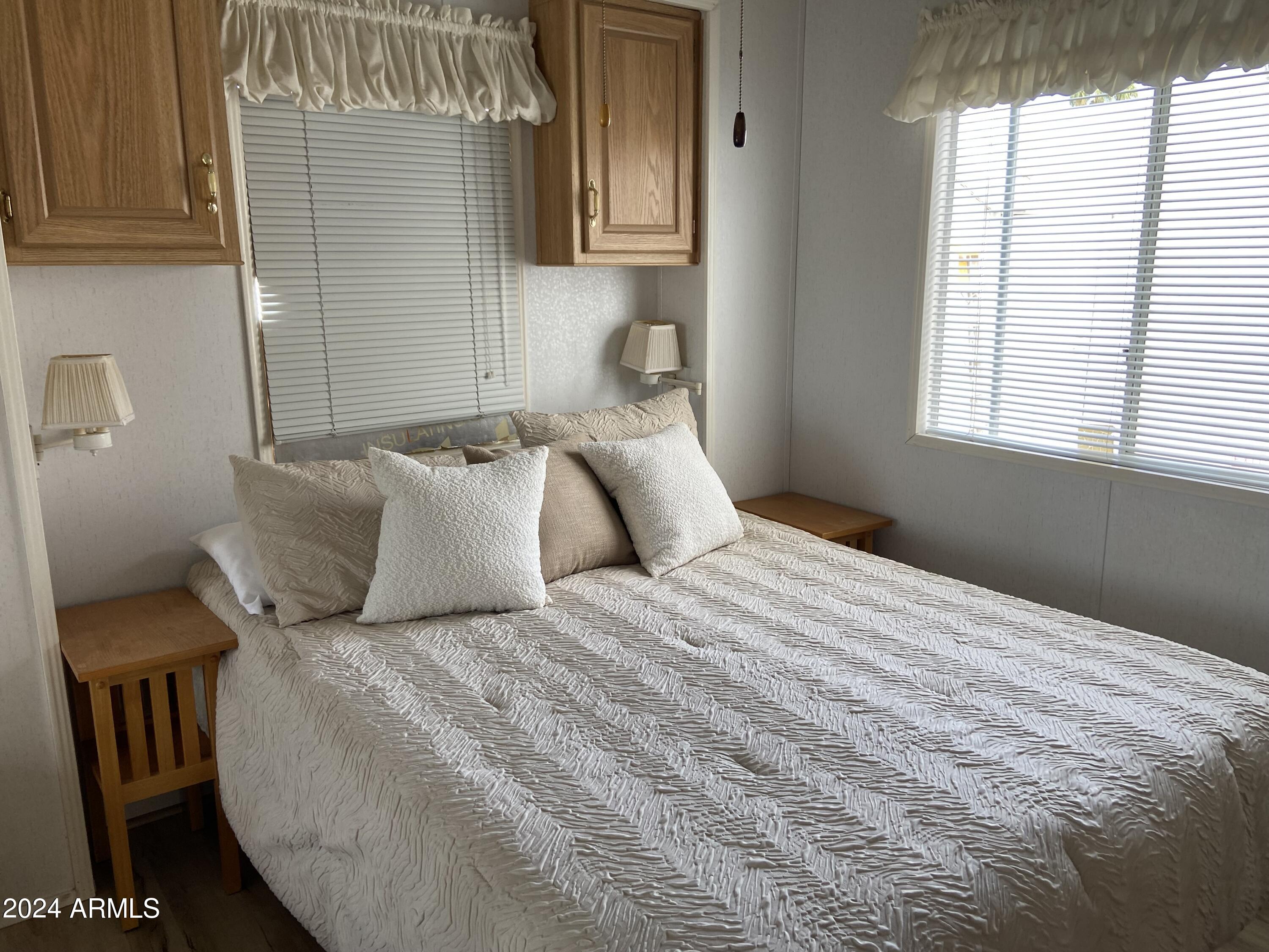 1226 Seneca Drive Apache Junction, AZ 85119 - Photo 3 of 23 a bedroom with a bed and window