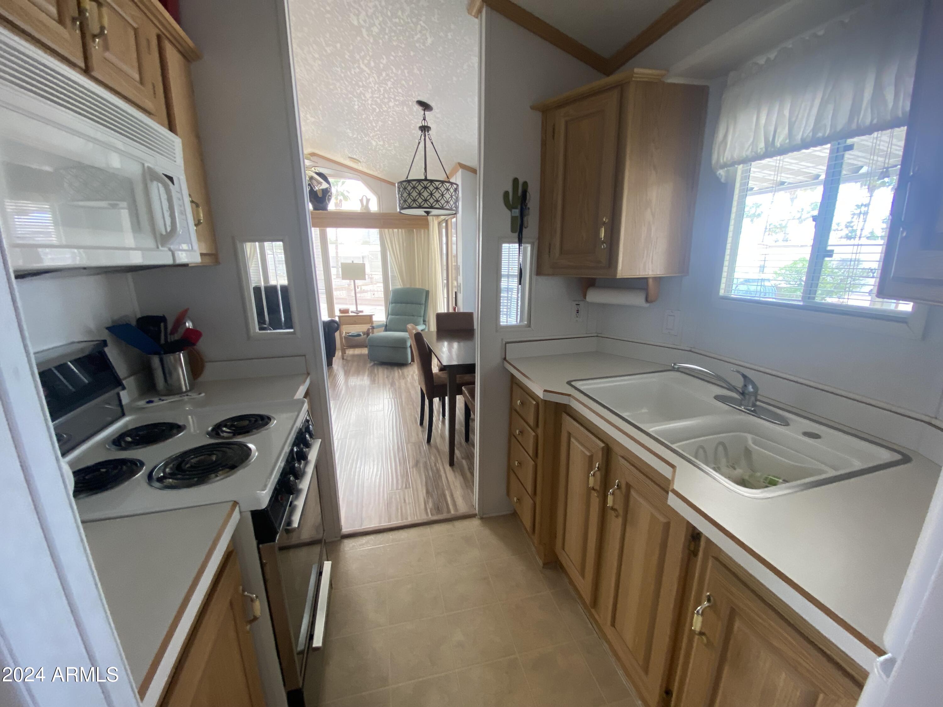 1226 Seneca Drive Apache Junction, AZ 85119 - Photo 6 of 23 a kitchen that has a sink a stove and cabinets