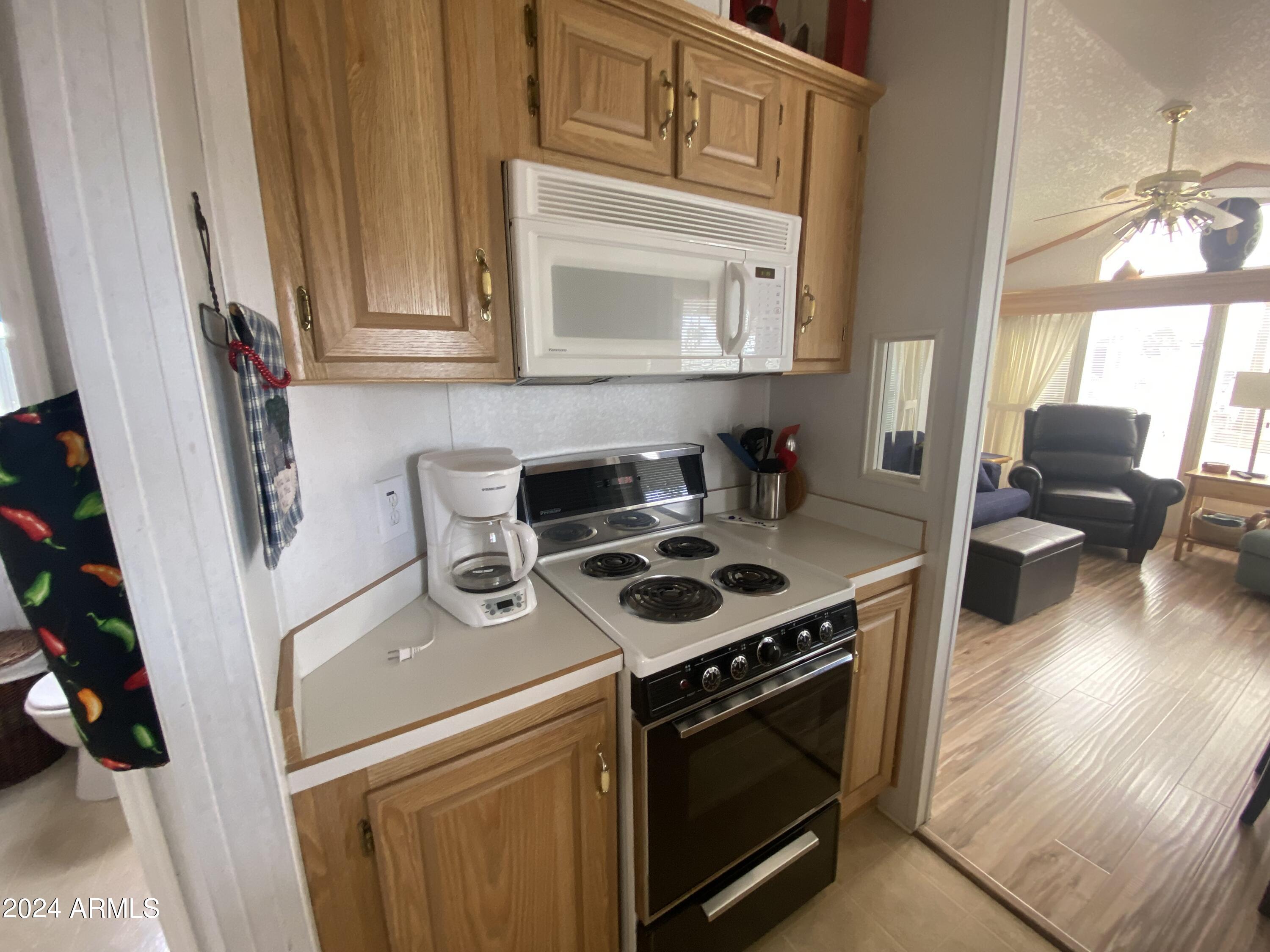 1226 Seneca Drive Apache Junction, AZ 85119 - Photo 7 of 23 a stove top oven sitting inside of a kitchen