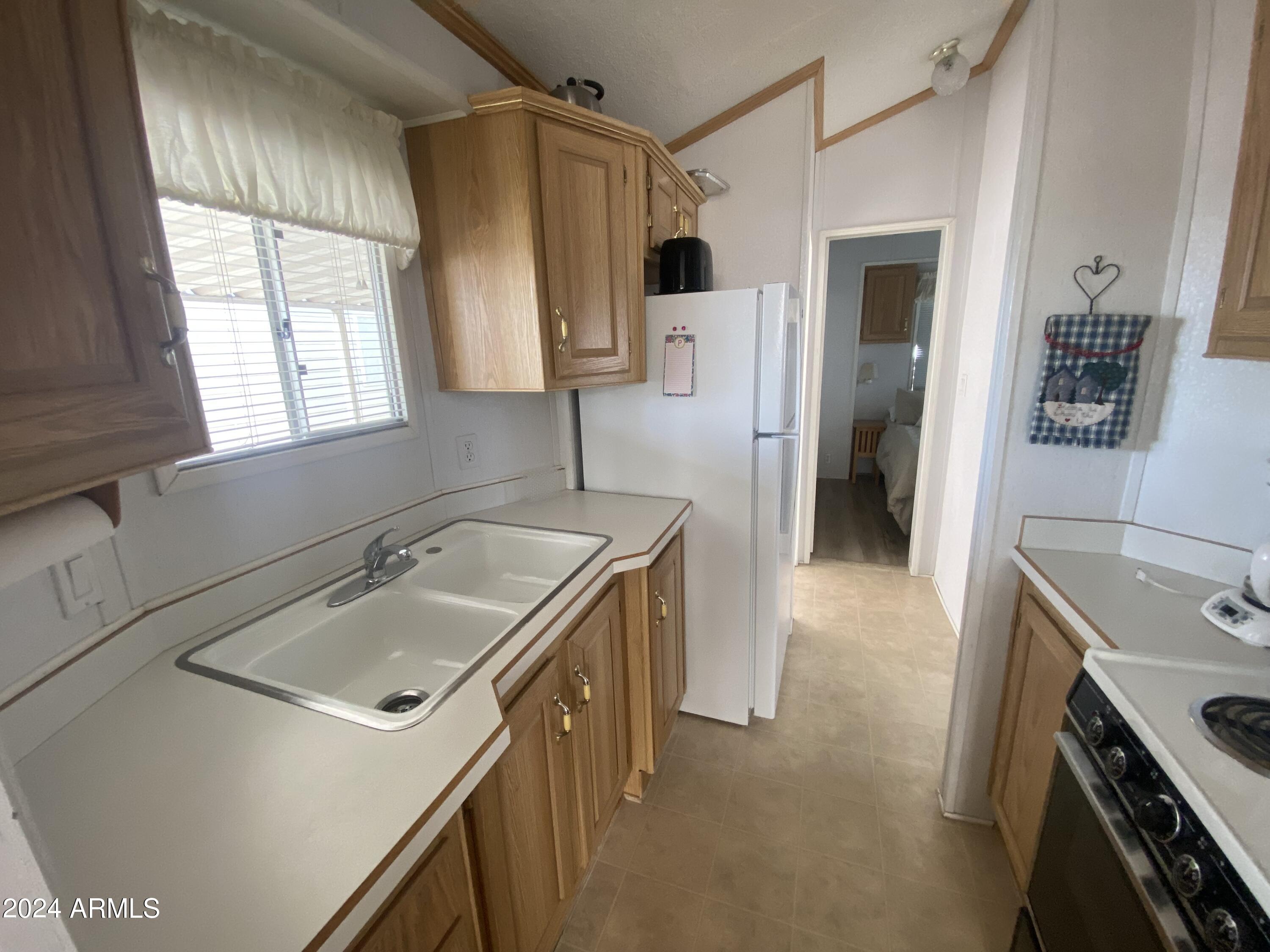 1226 Seneca Drive Apache Junction, AZ 85119 - Photo 8 of 23 a kitchen with a sink stove and refrigerator