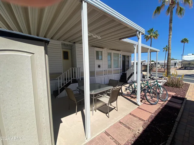 a view of a patio with table and chairs and potted plants