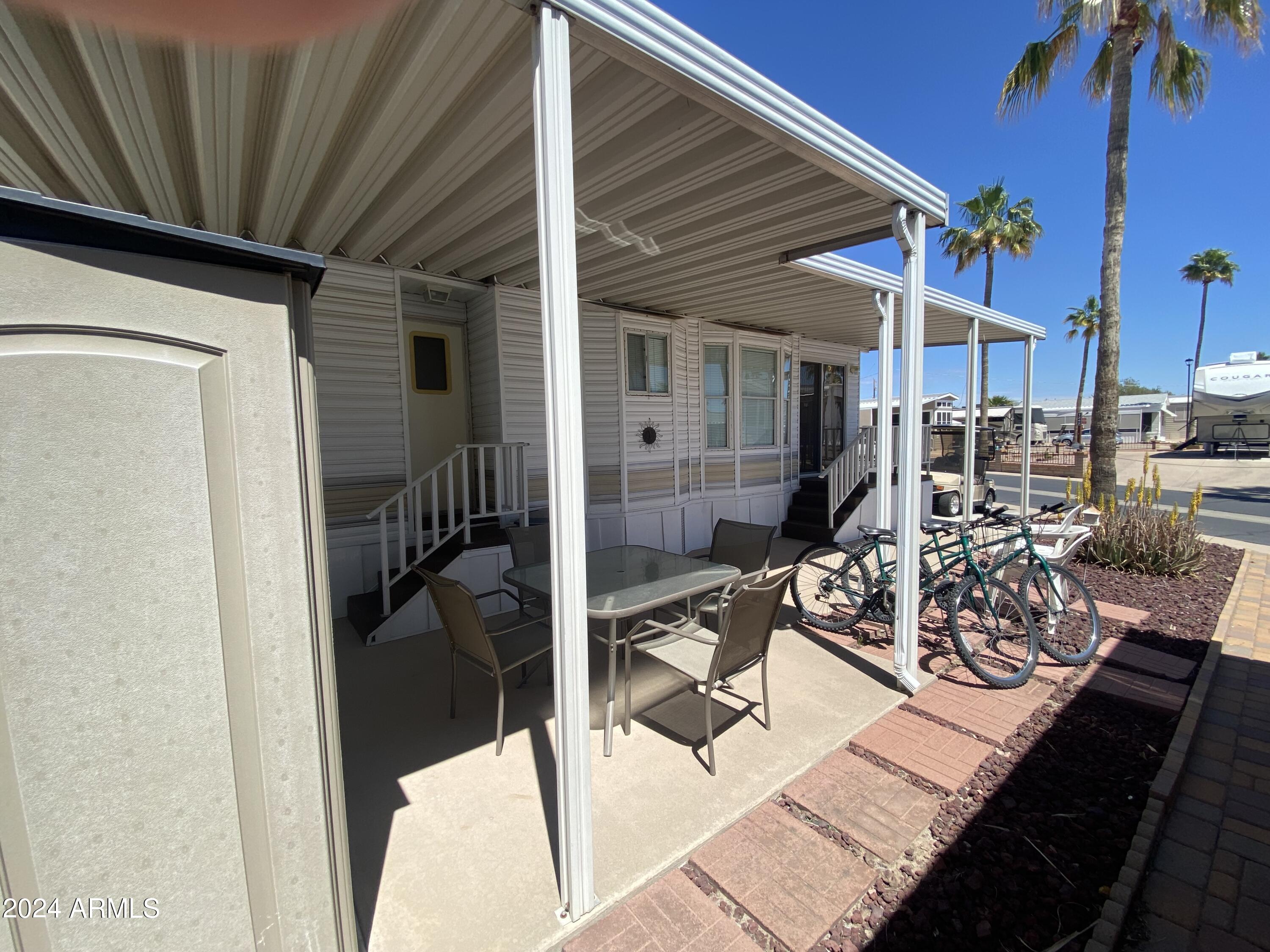 1226 Seneca Drive Apache Junction, AZ 85119 - Photo 9 of 23 a view of a patio with table and chairs and potted plants