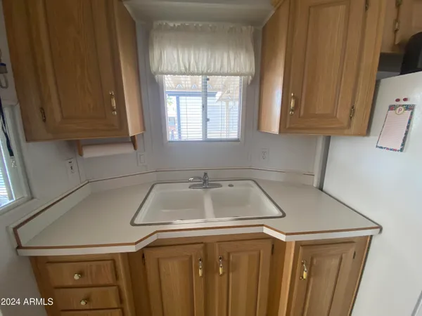 a kitchen with a sink cabinets and a window