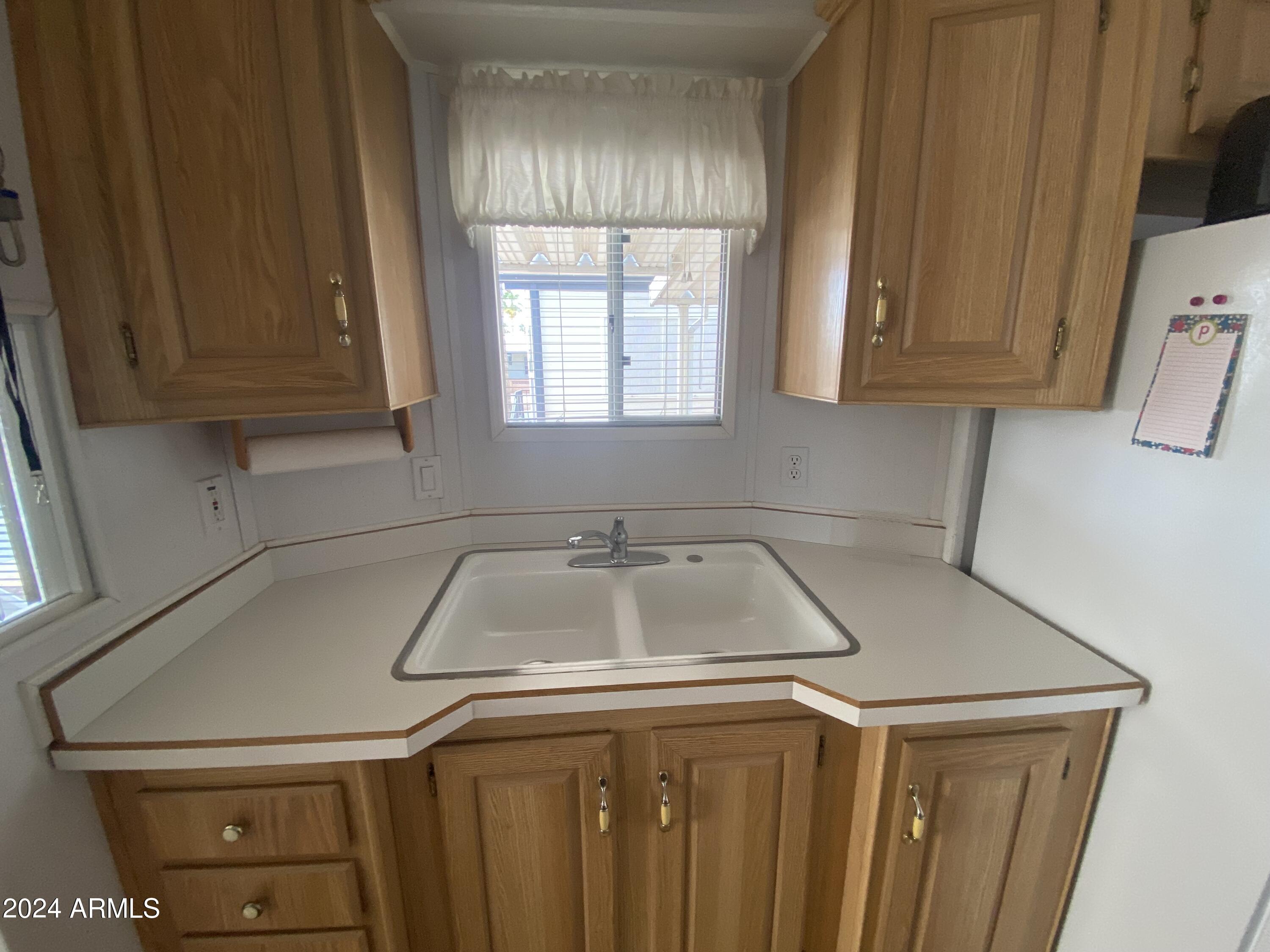 1226 Seneca Drive Apache Junction, AZ 85119 - Photo 10 of 23 a kitchen with a sink cabinets and a window