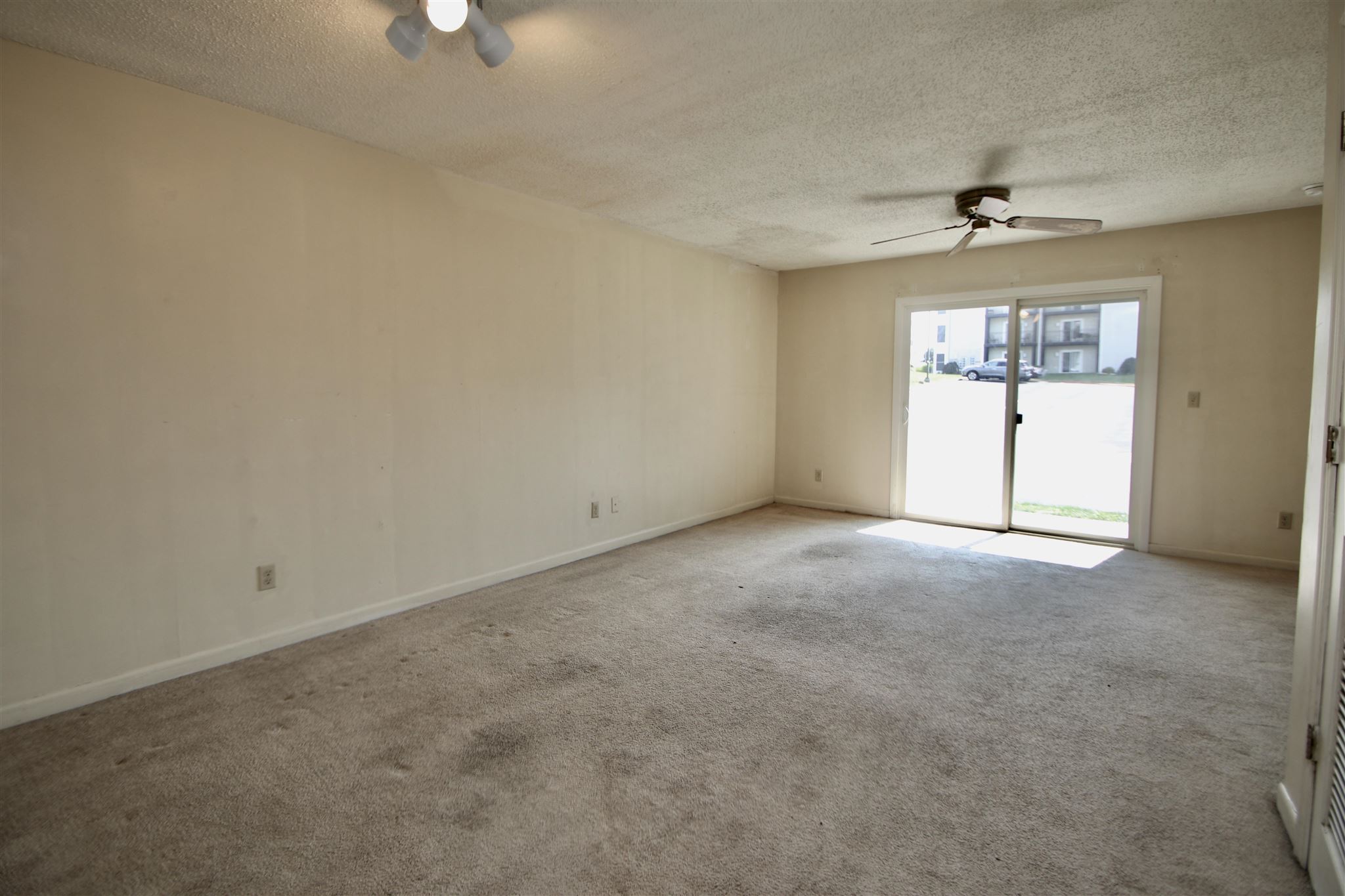 1360 Hunters Road, Unit A Harrisonburg, VA 22801 - Photo 6 of 13 an empty room with a window and a ceiling fan