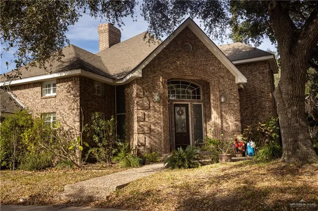 a front view of a house with trees