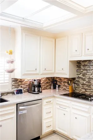 a kitchen with white cabinets and appliances