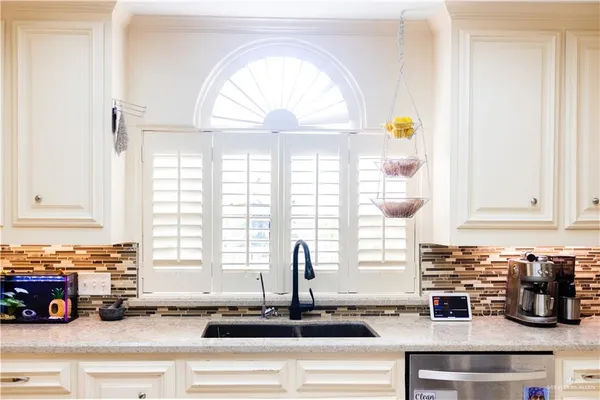 a kitchen with a sink and a window