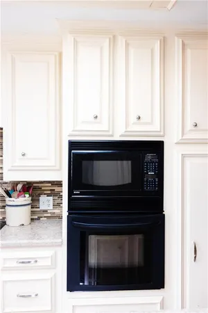a kitchen with stainless steel appliances granite countertop a stove microwave and cabinets