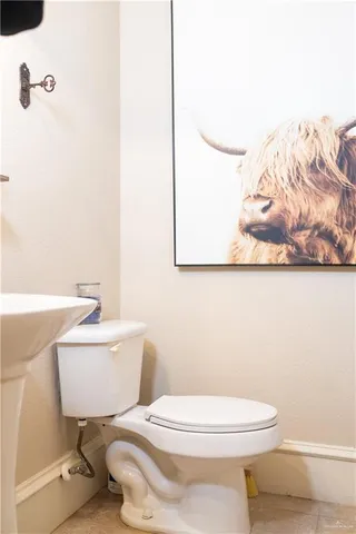 a white toilet sitting next to a bathroom sink