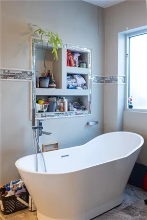 a living room with furniture and a book shelf